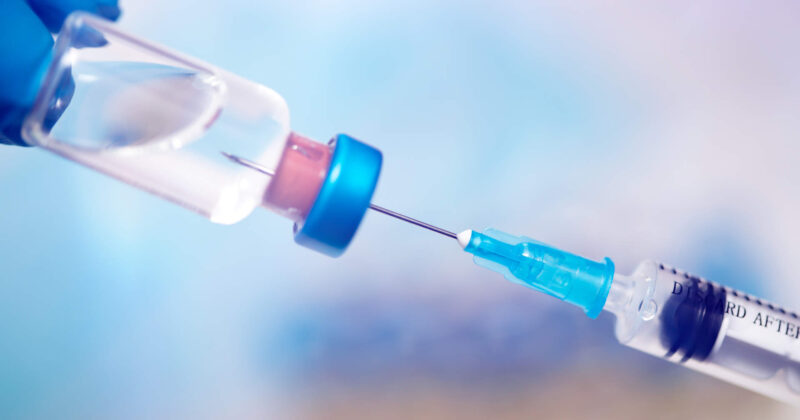 close-up-on-vaccine-and-medical-syringe-FQC8XNL